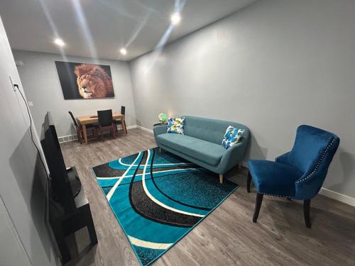 a living room with a couch and two chairs at Cute Highland Park Entire Unit A in Calgary