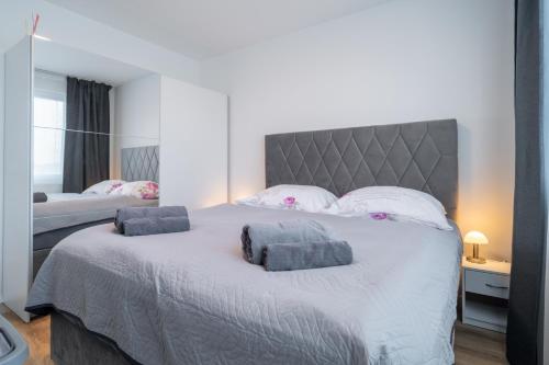a bedroom with a large bed with two pillows on it at NEW Luxury 2 bedroom apartment, fully airconditioned, near the airport, FREE Parking in Bratislava