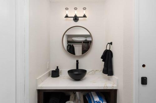 a bathroom with a sink and a mirror at Enjoy the Best Ocean Views in a Beach Front Condo in South Padre Island