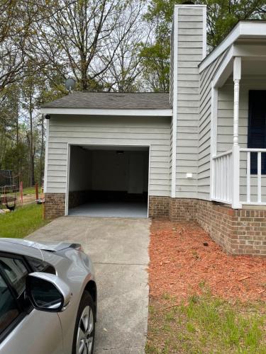 a garage with a car parked in front of it at Unwind in Tranquil Style - Spacious 3-Bed Haven in University Place