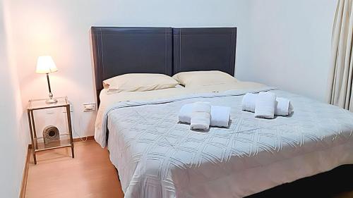 1 dormitorio con 1 cama grande y toallas. en Quinta Parque Mendoza en Mendoza