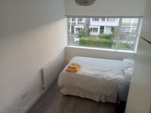 a small bedroom with a bed and a window at Home away from home in Dublin