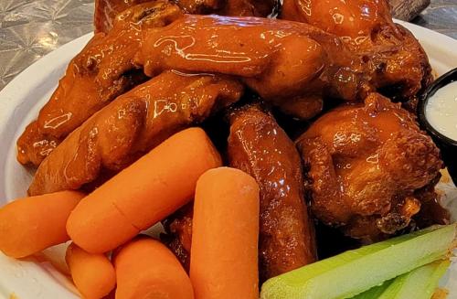 a plate of food with chicken and carrots and sauce at La Copa Inn Beach Hotel in South Padre Island