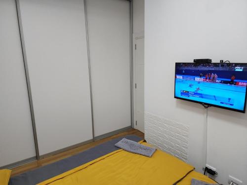a room with a flat screen tv on a wall at Apartman Relja in Novi Banovci