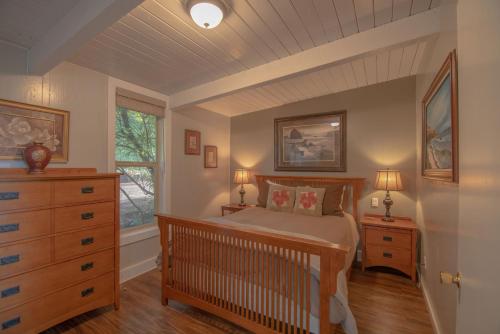 a bedroom with a crib and a dresser and a window at Oceanview Home with Hot Tub, Fenced Yard, and Dog-Friendly in Lincoln City