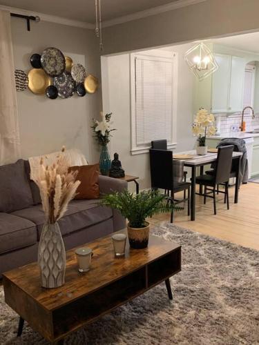 a living room with a couch and a table at Be our guest BOHO 2.0 in Charlotte
