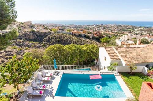 a villa with a swimming pool and a view of the ocean at Villa Romeo, with brand new salt water pool in Benalmádena
