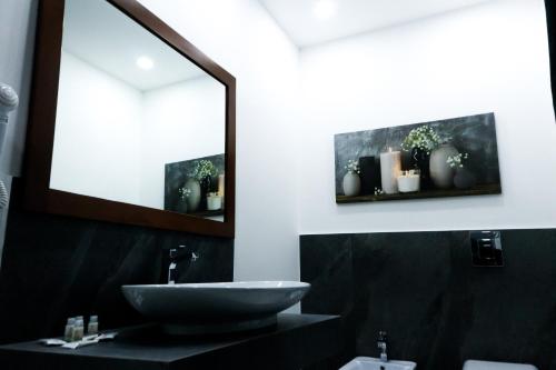a bathroom with a sink and a mirror at Alma House in Portici