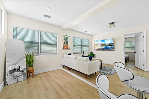 a living room with a couch and a table at Recently Remodeled Mins from beach+Putting Green in Boynton Beach