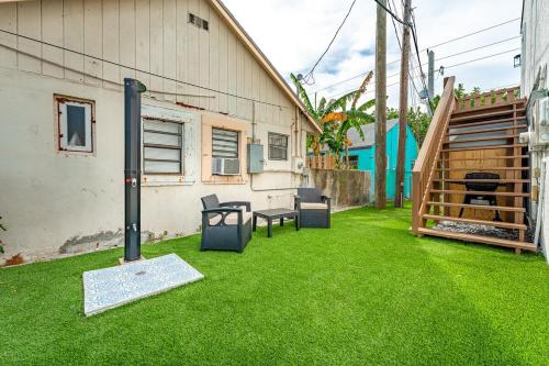 a yard with green grass and a house at Recently Remodeled Mins from beach+Putting Green in Boynton Beach