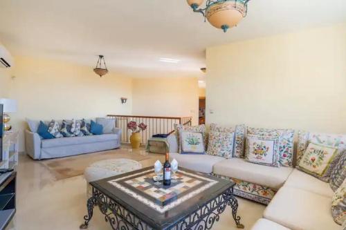 ein Wohnzimmer mit einem Sofa und einem Tisch in der Unterkunft Villa Romeo, with brand new salt water pool in Benalmádena