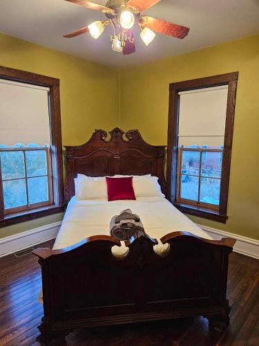 a bedroom with a large bed with a ceiling fan at Arcadia Academy in Arcadia