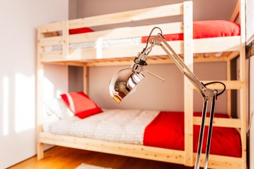 a lamp in a room with bunk beds at Bo&Co Apartments in Sitges