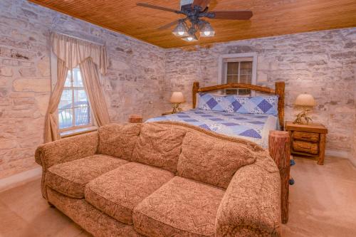 a bedroom with a bed and a couch at Country Inn Cottages in Fredericksburg