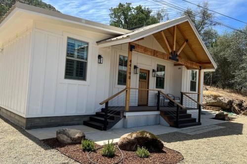 Soleil Luna 2 miles from Sequoia Park Entrance في ثري ريفرز: منزل أبيض صغير مع شرفة والدرج