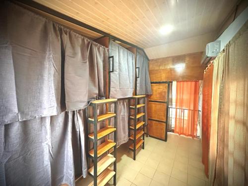 une petite chambre avec des rideaux et des étagères dans une maison dans l'établissement Blasina el valle, à El Valle de Antón