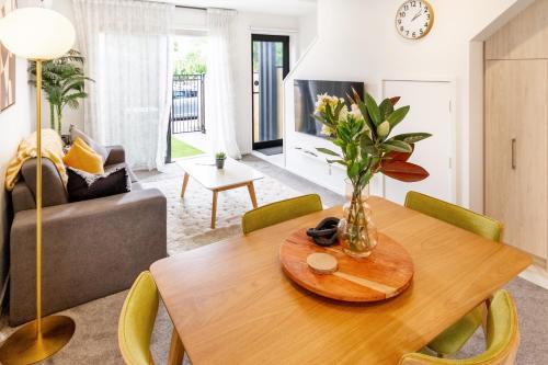 a living room with a table with a vase on it at Prime Location: Hagley, Riverside, Hospital in Christchurch
