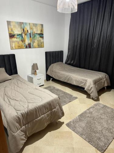 Łóżko lub łóżka w pokoju w obiekcie appartement s2 a jardin de Carthage