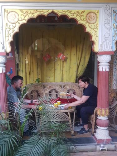two men sitting at a table in front at Sureli Haveli in Jaipur