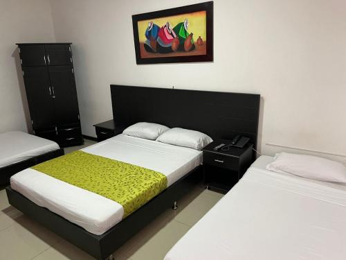 En eller flere senge i et værelse på Hotel El Jardín Cafetero Armenia