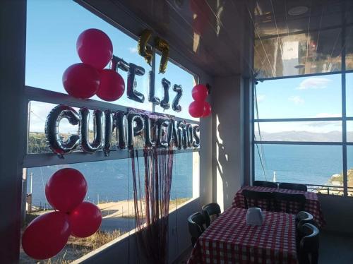 a room with a table with red balloons in a window at Playa Blanca Baruch Glamping Tota in Tota