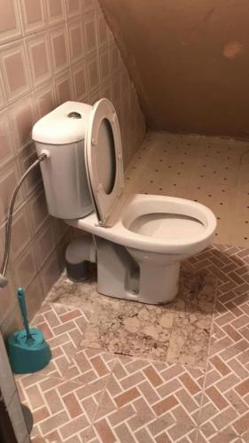 a toilet with the seat up in a bathroom at Maison d’hôtes ATLAS ait alla in Tan-Tan Plage