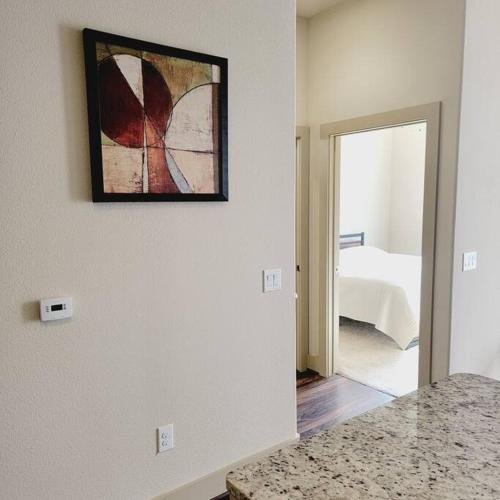 a room with a painting hanging on the wall at Relaxing Pool View Apt Reliant Stadium/Medical Center in Houston