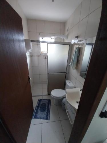 a small bathroom with a toilet and a sink at Casa da ana in Penha