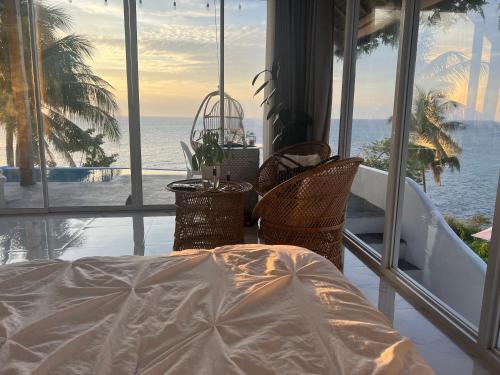 a room with a bed and a view of the ocean at Bintana Sa Paraiso in Mambajao