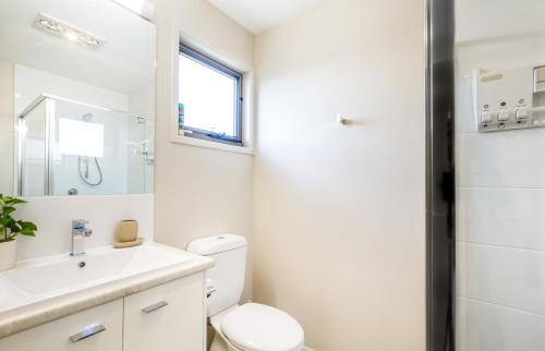 a white bathroom with a toilet and a sink at Beautiful Mountain Townhouse Entire home to yourself in Beerwah