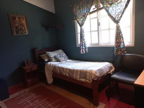 a small bedroom with a small bed and a window at Quinta Don Diego in Piñero