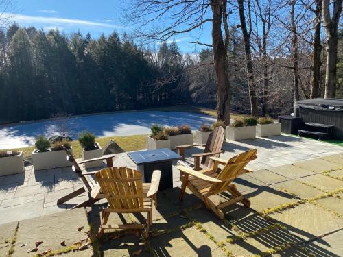 a patio with two chairs and a table at Catskills Pond Getaway in Liberty