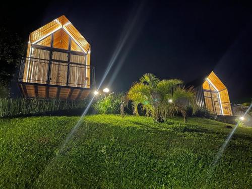 a house on a grassy hill at night with lights at Alta Vista Cabanas in Garibaldi