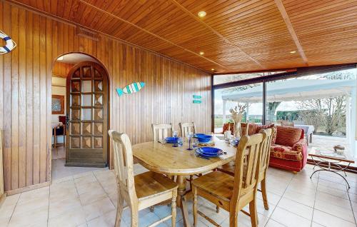 a dining room with a wooden table and chairs at Stunning Home In La Bazouge-De-Chemeré in La Cropte