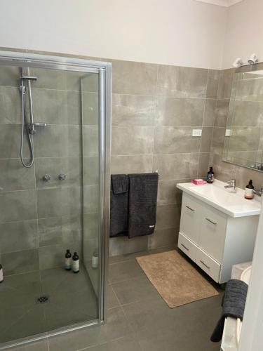 a bathroom with a shower and a sink at Central Yarrawonga in Yarrawonga