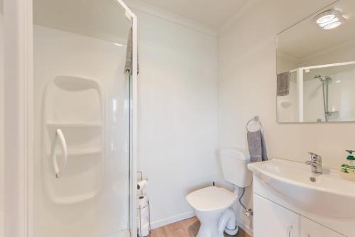 a bathroom with a shower and a toilet and a sink at Central CBD in Motueka