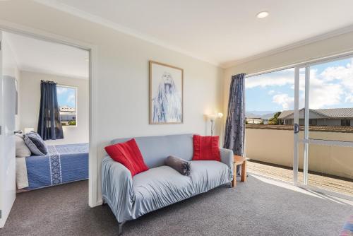 a living room with a couch and a bed and a window at Central CBD in Motueka