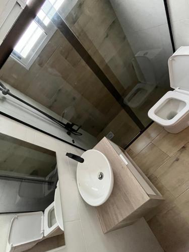 a bathroom with a sink and a toilet at Casa con piscina climatizada in Ciudad de la Costa