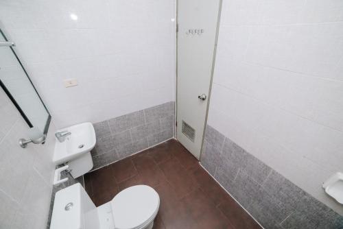 a small bathroom with a toilet and a shower at GC Hotel in Zamboanga