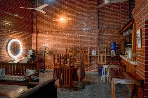 a room with a brick wall and tables and chairs at Country house, friends, meetings, well connected in Luque