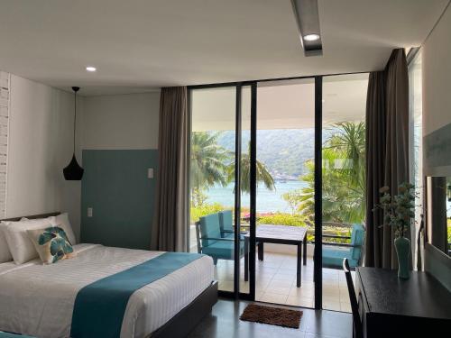 a bedroom with a bed and a table and a balcony at M Villa Nha Trang in Nha Trang