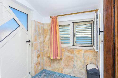 a bathroom with a shower with a window at Apartments by the sea Sevid, Trogir - 4287 in Sevid