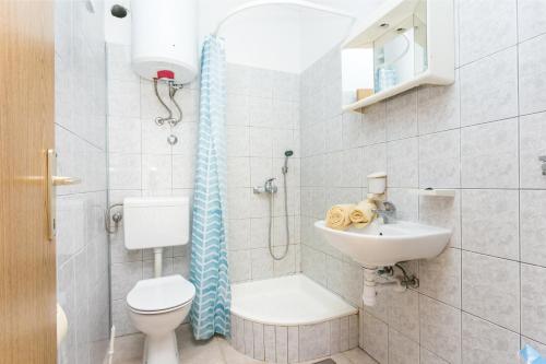 a bathroom with a toilet and a sink and a shower at Apartment Sevid 4287d in Sevid