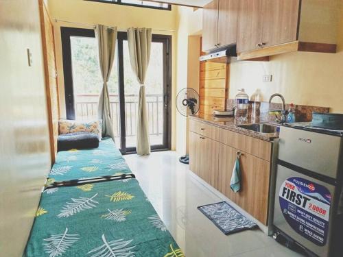 a kitchen with a bench in the middle of it at Evergreen Suites Cozy Baguio Loft Retreat in Baguio