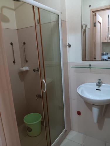 a bathroom with a shower and a sink at October Homes, Field Residences, Sucat, Parañaque, Airport Express in Manila