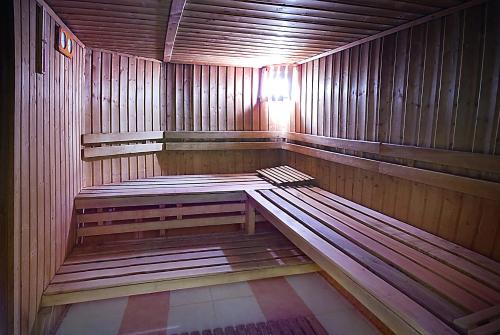 a wooden sauna with a bench in the middle at Vila Teleconstructia in Slănic-Moldova