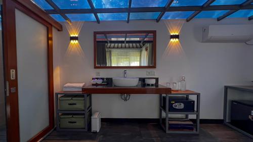 a bathroom with a sink and a mirror at Green Valley Lombok in Selong Belanak