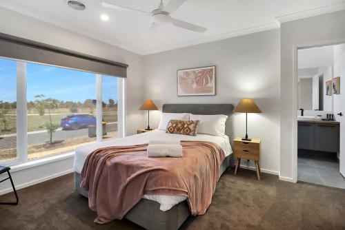 um quarto com uma cama grande e uma janela grande em Retreat on Bedajanawa em Geelong