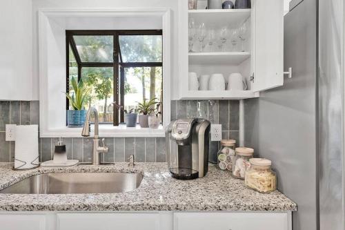 a kitchen with a sink and a counter top at Middle Sound Hideaway~Beaches, Shopping, Families in Wilmington