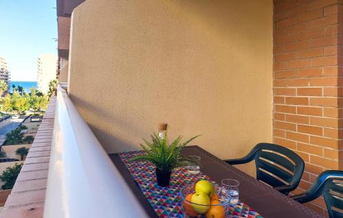 a wooden table with fruit on a balcony at 2 Bedroom Nice Apartment In Oropesa Del Mar in Oropesa del Mar